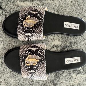 Jimmy Choo Black and Gold Flats with Luxe Emblem